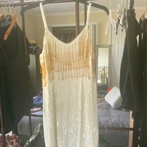 White sleeveless sequined dress with gold bead tassels. Size small.